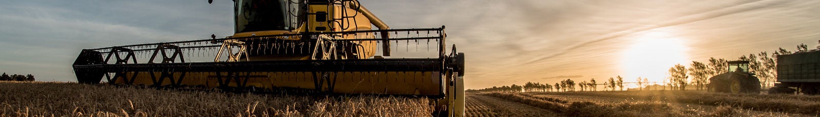 Image of tractor/combine harvester in a field.