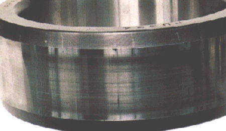 Straight axial scratches on raceway surface of CRB inner ring.