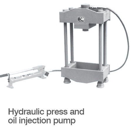 A hydraulic press attached to an oil injection pump.